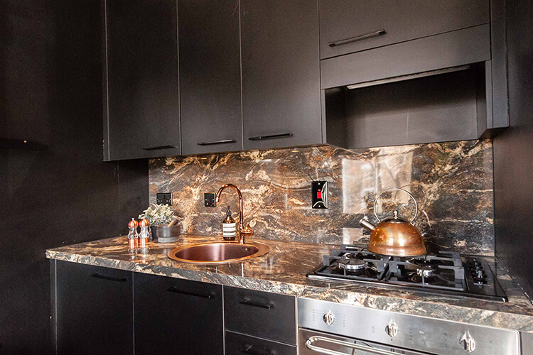 Black kitchen with marble